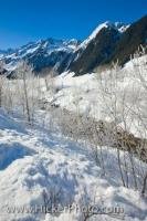 The scenery is beautiful as an alpine river amongst the frozen trees winds its way through the winter landscape of Wildgerlos Valley in Salburger Land in Austria.