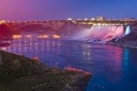A picturesque scene is the night illumination of the American Falls and the Rainbow Bridge which is spectacular from the Canadian side of the Niagara River in Ontario.