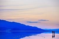 Beautiful reflections in blue as dusk falls upon Badwater Basin in Death Valley National Park, California, USA.