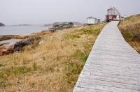 The waterfront boardwalk takes visitors from one place to another in the historic fishing village of Battle Harbour in Southern Labrador, Canada.