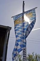 The Bavaria Bayern Flag is raised during the Maibaumfest in Putzbrunn, Germany.