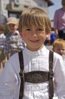 A young boy dressed in traditional lederhosen poses during the Maibaumfest in Putzbrunn, Germany.