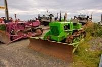 Beautiful colored bulldozers along the beach of Ngawi, New Zealand used to haul the boats out of the water.