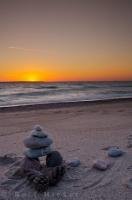 This beautiful sunset scene shows a stone man formation along the beach at Agawa Bay on the shores of Lake Superior in Ontario Canada. Lake Superior Provincial Park is known for its varied shores and beautiful surroundings.