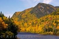 Deep in the heart of Parc de la Jacques-Cartier during fall, the hills and mountain slopes are carpeted in beautiful blazing scenery and colour alongside the Jacques-Cartier River in Quebec, Canada.