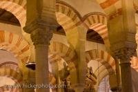 A multitude of impressive, colorful arches highlight the beautiful Mezquita de Cordoba, an 8th Century mosque that is now used as a cathedral, located in Cordoba, Andalusia, Spain.