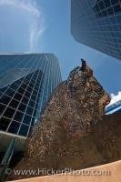 The high rise towers and detailed bison sculpture can be seen from down below looking towards the sky in the Frederick W Hill Mall in Regina, Saskatchewan - an open air pedestrian mall in the centre of the city.