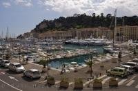 Along the Cote d'Azur in Nice, Provence in France there is a beautiful boat marina which lines the waterfront with the Parc du Chateau adorning the backdrop.
