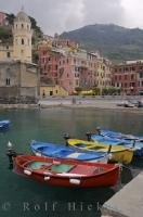 A colourful line up of small fishing boats in the Vernazza Harbour, Liguria, Italy.