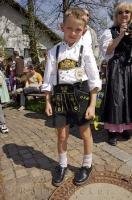 A young boy at the Maibaumfest in his traditional Bavarian Lederhose in Putzbrunn, Germany.