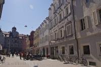 In Bruneck, Italy pedestrians stroll the intimate town lane amongst the businesses and shops.