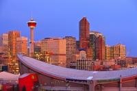The famous Calgary Tower looms above the unique roof line of the Saddledome Stadium in the city of Calgary, Alberta, Canada.