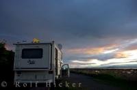 Parked at the Sebka Campground on the Gulf of St. Lawrence in Kamouraska, Quebec, a beautiful sunset enlightens the area which can easily be seen from comfort of our camper.