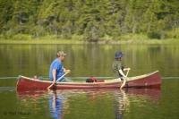 A couple paddling away on a canoe tour in Northern Newfoundland near Main Brook