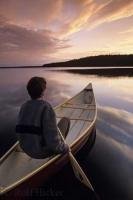 During a vacation to Tuckamore Lodge in Newfoundland, Canada enjoy canoeing at sunset from the banks of a pristine lake right outside the lodge.