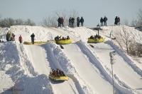 While most carnivals feature rides on a feris wheel, a popular ride at the Quebec Winter Carnival is careering down an icy hill in an inflatable raft.