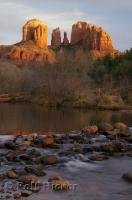 The sun sets and turns Cathedral Rock in Sedona, Arizona from red rock to gold.