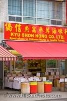 A bright red sign above the awning at a Chinese store in Chinatown in Toronto, Ontario which specializes in health foods.
