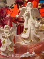 A set of two pretty angels adorn the shelves of a shop at the annual Christmas Markets held in the historic town of Regensburg, Bavaria, Germany.