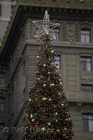 A brightly decorated christmas tree topped with a star in downtown San Francisco, California, USA.