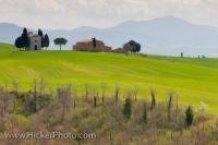 A small church sits on the hillside on the sunny Tuscan landscape en route to the town of Pienza in the Province of Siena in Italy, Europe.