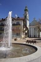 The water in the circular fountain glistens in the sun in the town square of Toblach in the South Tyrol of Italy.