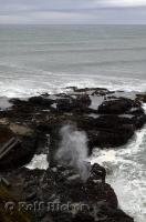 The pounding Pacific Ocean surges and forces water through the blow hole at Cooks Chasm in Oregon.