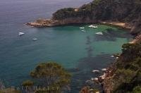 The azure waters of the Mediterranean Sea lap at the coast of the Costa Brava in Catalonia, Spain.