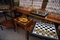 Crafted chess sets for sale at a market stall near the famous Ponte di Rialto in Venice, Italy.