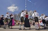 A group dance in front of the Maibaum during the Bavarian cultural Maibaumfest in Putzbrunn, Germany.