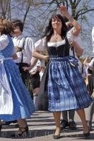 A woman participates in traditional Bavarian dancing in Putzbrunn, Germany.