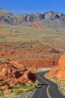 From the winding road, across the desert floor to the hills in the background, a medley of colours paint the landscape in the Valley of Fire State Park of Nevada, USA.