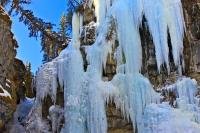 These are amazing ice formations draping from the walls of the Johnston Canyon at the Upper Falls location during the winter in the Canadian Rocky Mountains. Johnston Canyon is located in Alberta in Banff National Park.