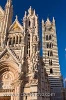 The facades of the Duomo and the Campanile are very different in the medieval City of Siena in Tuscany, Spain.