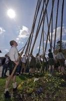 Long poles help the European men lift the Maibaum into place in Putzbrunn, a village near Munich, Germany.