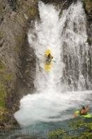 Waterfall running the extreme watersport of paddling over a waterfall in a kayak.