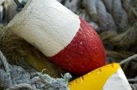 Colorful buoys are attached to fishing nets or lobster traps around Cape Palmerston on Northern Vancouver Island in British Columbia.