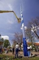 The signs attached to the Maibaum during a historical Maibaumfest in the German village of Putzbrunn, Germany.