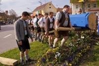 A team of German men, dressed in traditional Bavarian lederhosen, lift the Maibaum in the town of Putzbrunn, Germany.