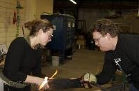Two artists work on a piece during a glass blowing demonstration at the Lincoln City Glass Center in Oregon.