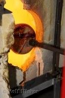 Although the magic is performed by the artist in glass blowing the heat from the furnace keeps the glass pliable.