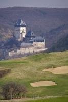 A popular vacation destination in the Czech Republic is the Karlstein Golf Course with stunning views of the Castle.
