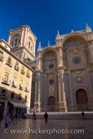 The facade of the Granada Cathedral in the City of Granada in Andalusia, Spain, gleams under the deep blue sky during the summer months.