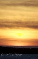 The clouds glow above Grays Harbor during sunset in Westport, Washington, USA.