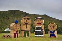 A family of hay bales stand along the roadside in the town of Kurow in the Waitaki Valley in North Otago, New Zealand.