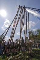 Long poles are used by the European people to raise the historic Maibaum in Putzbrunn, Southern Bavaria.