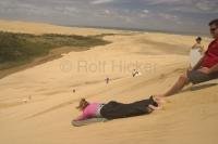 Young people enjoying hot rides on the sand dunes of Te Paki in Northland, New Zealand near Cape Reinga.