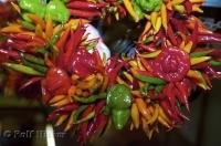 A brightly coloured wreath of hot peppers on display at the Public Market Center in downtown Seattle, Washington, USA.