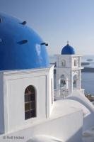 A classik Santorini Image with a white church and blue roofs