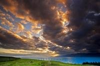 Fascinating cloud formations of extraordinary hues fill the sky at sunset over South Bay and the Kaikoura Coast on the South Island of New Zealand.